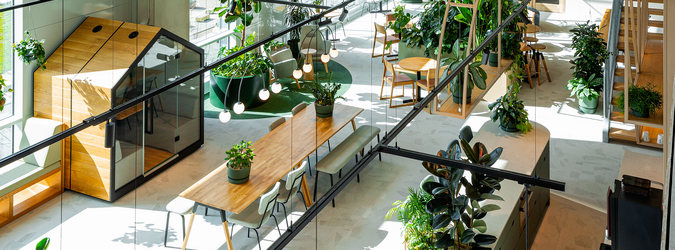 Modern lounge and waiting area with armchairs and round table in a sustainably designed office building