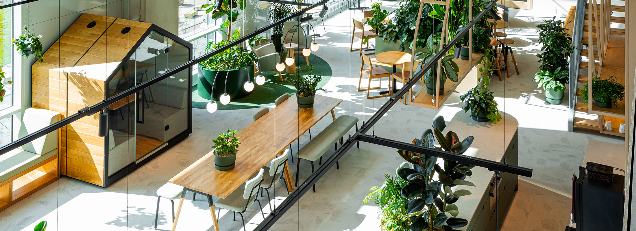 Modern lounge and waiting area with armchairs and round table in a sustainably designed office building