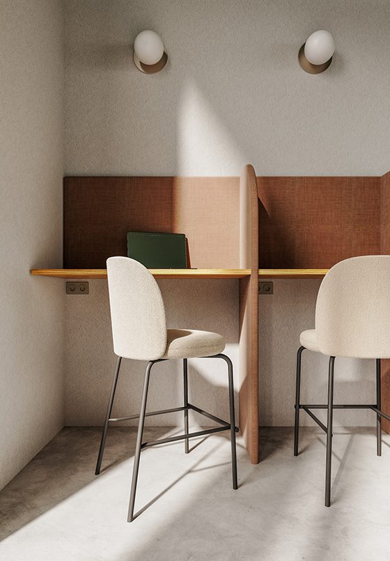 Ruhige Einzelarbeitsplätze mit hohen Barhockern, indirekter Beleuchtung und akustisch abgeschirmtem Design.