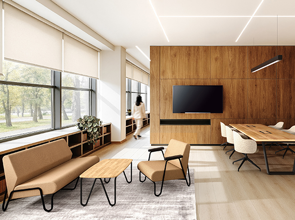 Heller Loungebereich mit Sofas, Holzverkleidung und integriertem Besprechungstisch, geprägt von viel Tageslicht.