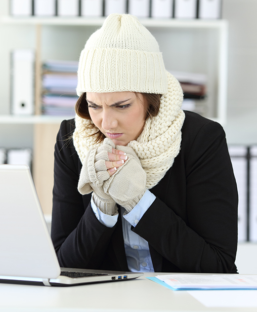 Frau im Büro friert