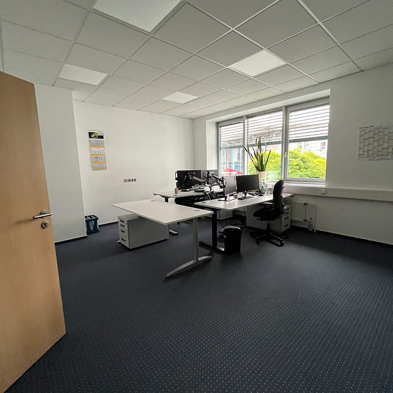 Existing office space prior to refurbishment with workstations and natural daylight.